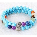  Meditationsarmband mit Buddhakopf und türkisfarbenen Perlen