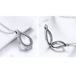 Silberne Halskette mit zu öffnendem tropfenförmigem Anhänger, weiß