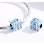 Ezüst charm, bőrönd