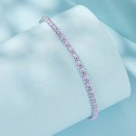 Ezüst karkötő lila zsinórral