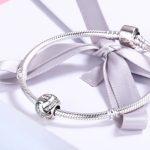 Ezüst charm, csomó